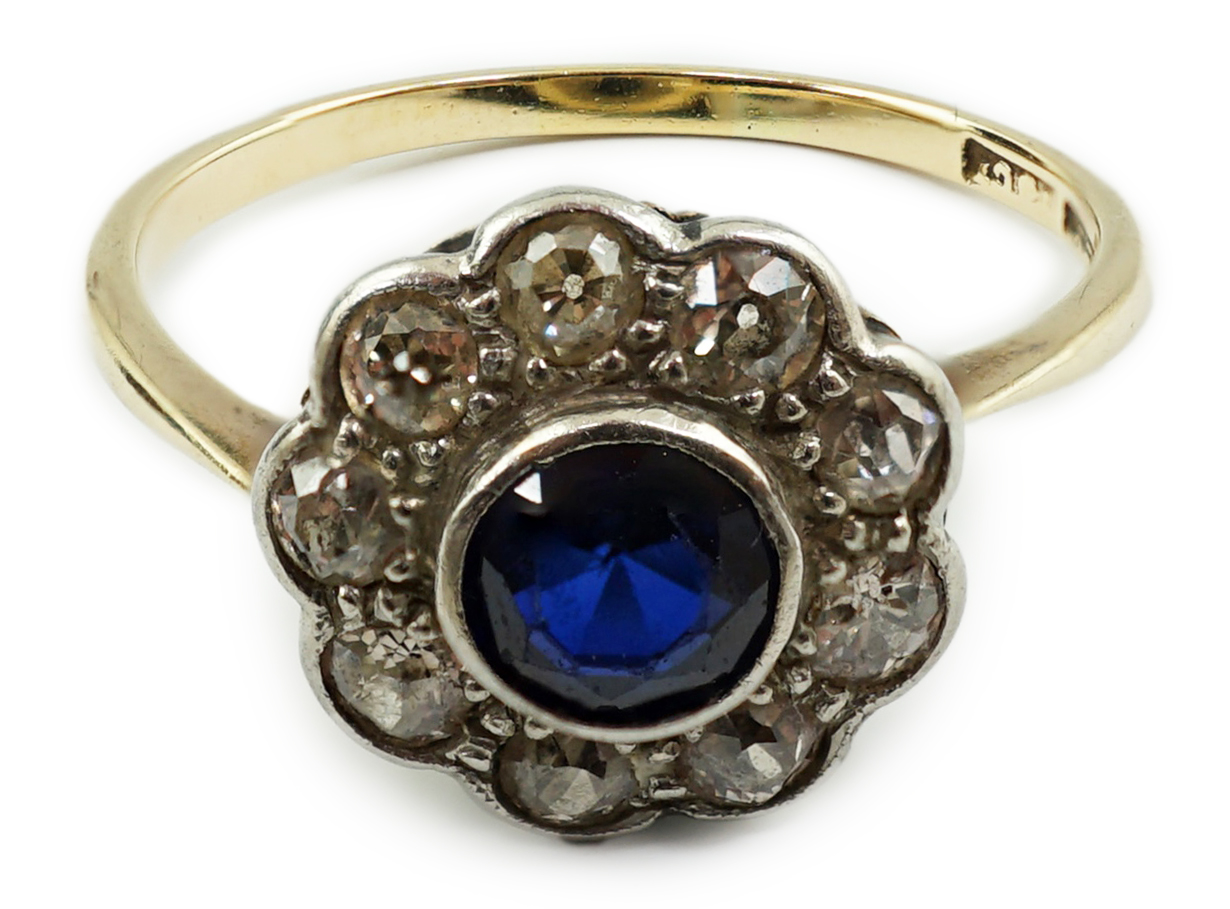 A 1920's 18ct gold, sapphire and diamond set flower head cluster ring